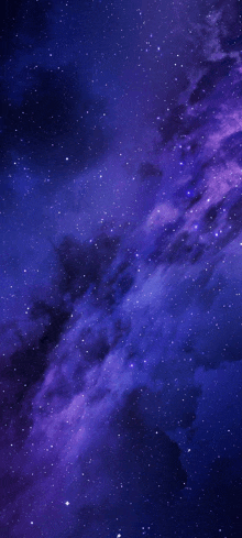 a purple galaxy with lots of stars in the night sky