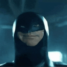 a close up of a man in a batman mask