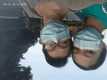 two people wearing face masks and glasses with the date 2020/11/10 on the bottom right