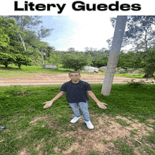 a boy is standing in the grass with his arms outstretched in front of a sign that says litery guides