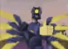 a purple robot with yellow wings is standing in front of a yellow building .