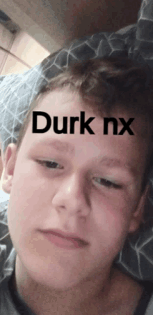 a close up of a person 's face with the words " durk nx " on it