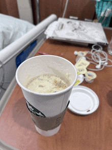 a cup of starbucks coffee sits on a hospital table