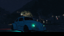 a blue car is parked in the dark with green lights on