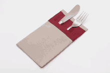 a knife and fork are in a napkin holder