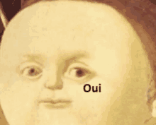 a painting of a baby 's face with the word oui written on it .