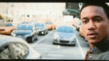 a man stands in front of a busy street