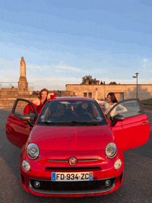 a red fiat car with the license plate fd 934 zc