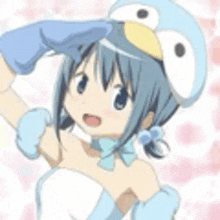 a girl in a penguin costume is making a heart with her hands .