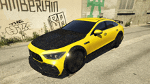 a yellow car is parked in front of a wall that has graffiti on it that says " the gsb "