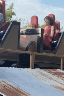 a woman and a child ride a roller coaster called route 66