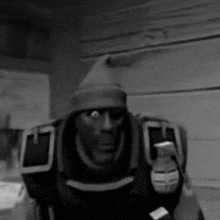 a black and white photo of a cartoon character wearing a hat and holding a grenade .