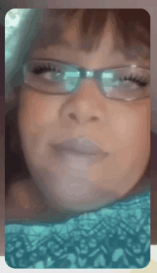 a close up of a woman 's face with glasses on