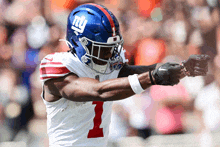 a new york giants football player wearing a blue helmet