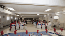 a large room with tables and chairs set up for a dinner party