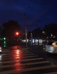 a busy intersection at night with a sign that says " a " on it