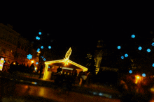 a blurred image of a christmas market at night with a star in the middle