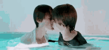 a couple of people are kissing in a pool .