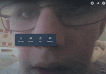 a screen shot of a person 's face with a blue button that says " shut down "