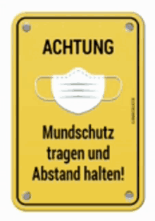 a yellow sign that says achtung mundschutz tragen und abstand halten