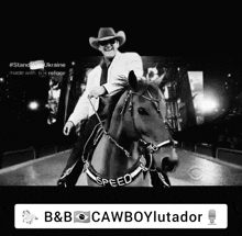 a black and white photo of a man riding a horse with the word speed on the bridle