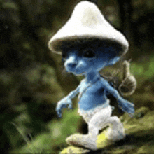 a blue smurf with a white hat is walking through the woods .