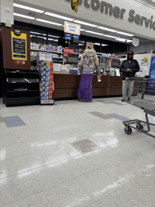 a woman in a purple skirt stands in front of a counter that says comer service