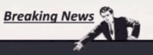 a man in a suit is pointing at a breaking news banner