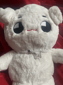 a stuffed animal with a necklace around its neck