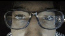 a close up of a person 's face with glasses