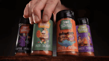 a hand reaches for a bottle of grizzly inferno ghost stores