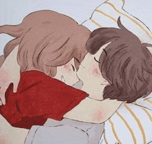 a boy and a girl are hugging each other and kissing while laying in bed .