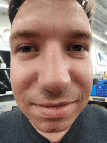 a close up of a man 's face with a gray shirt