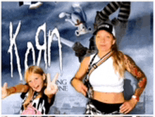 a woman and a little girl are posing for a picture with the word korn on the background