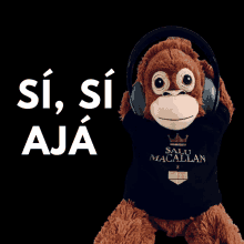 a stuffed monkey wearing headphones and a shirt that says salu macallan on it