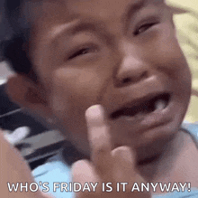 a young boy is crying and giving the middle finger while saying who 's friday is it anyway .