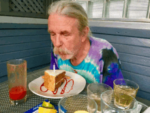 a man is blowing out a candle on a piece of cake