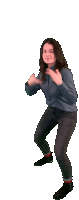 a woman in a denim shirt and jeans is dancing