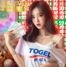 a woman wearing a white t-shirt with the word togel on it