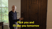 an elderly man is standing in front of a wooden door and says fuck you and i 'll see you tomorrow