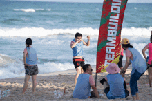 a group of people on a beach with a banner that says teambuildin on it