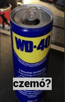 a can of wd-40 sits on a table next to a can of czemo