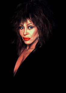 a close up of a woman 's face with red lips and a black background