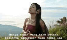 a woman in a red dress is standing in the grass with her eyes closed and the words hanya tuhan yang