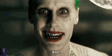 the joker from the movie suicide squad is smiling with braces on his teeth and red lipstick .