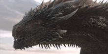 a close up of a dragon 's head with its mouth open