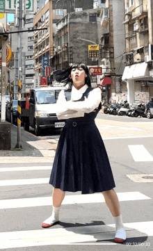 a girl in a school uniform is crossing a street in front of a building with a sign that says ' chinese restaurant '