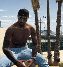 a shirtless man wearing sunglasses and a headband sits on a bench