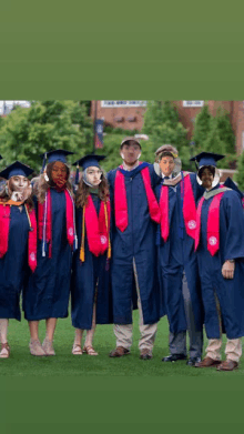 a group of graduates posing for a picture with their faces on their caps