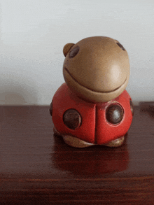 a ladybug figurine is sitting on a table